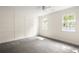 This spacious bedroom features a ceiling fan, two windows, and neutral carpeting at 178 Mayson Ne Ave, Atlanta, GA 30307