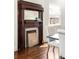 A close up of a vintage wood fireplace mantel with a white tile surround at 178 Mayson Ne Ave, Atlanta, GA 30307