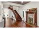 Elegant foyer with rich hardwood floors, staircase, fireplace and beautiful decorative accents at 178 Mayson Ne Ave, Atlanta, GA 30307