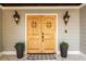 Stunning wood double doors flanked by lantern lighting, creating a warm and inviting entrance at 178 Mayson Ne Ave, Atlanta, GA 30307