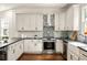 Bright kitchen with white cabinets, stainless steel appliances, and a stylish backsplash at 178 Mayson Ne Ave, Atlanta, GA 30307