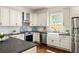 A light and airy kitchen with a farmhouse sink and stainless steel appliances at 178 Mayson Ne Ave, Atlanta, GA 30307
