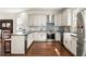 A white kitchen with a subway tile backsplash, stainless appliances, and dark countertops at 178 Mayson Ne Ave, Atlanta, GA 30307