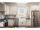 Updated kitchen with stainless appliances and dark countertops; lots of natural light at 178 Mayson Ne Ave, Atlanta, GA 30307