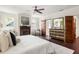 Spacious main bedroom features a fireplace, barn door access to the bathroom, and wood floors at 178 Mayson Ne Ave, Atlanta, GA 30307
