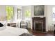 Bright main bedroom with a fireplace and a cozy seating area; windows provide natural light at 178 Mayson Ne Ave, Atlanta, GA 30307