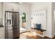 Bright mudroom featuring a shiplap accent wall, built-in bench, and stainless steel refrigerator at 178 Mayson Ne Ave, Atlanta, GA 30307