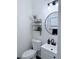Modern half bathroom with a stylish vanity, round mirror, and decorative shelving at 1991 Westover Nw Ln, Kennesaw, GA 30152