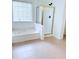 Bathroom featuring a bathtub and a shower with gold metal trim at 1991 Westover Nw Ln, Kennesaw, GA 30152