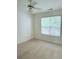 Cozy bedroom featuring a large window offering natural light and neutral carpet at 1991 Westover Nw Ln, Kennesaw, GA 30152