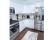 Modern kitchen with stainless steel appliances, granite countertops, and white cabinetry at 1991 Westover Nw Ln, Kennesaw, GA 30152