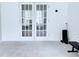 Bright living room featuring French doors and neutral carpet, offering a versatile living space at 1991 Westover Nw Ln, Kennesaw, GA 30152