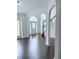 Elegant living room featuring dark wood floors, large archways, and abundant natural light at 1991 Westover Nw Ln, Kennesaw, GA 30152