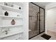 Modern bathroom featuring glass enclosed shower, open shelving and elegant decor at 2357 Heritage Park Nw Cir # 17, Kennesaw, GA 30144