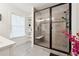 Modern bathroom with a glass shower featuring a built-in seat, and bright natural light from a window at 2357 Heritage Park Nw Cir # 17, Kennesaw, GA 30144