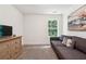 Bedroom featuring light grey sofa, neutral walls, carpet, and a window with lush view at 2357 Heritage Park Nw Cir # 17, Kennesaw, GA 30144