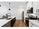 Modern kitchen featuring white cabinets, stainless steel appliances, and a large island with a sink at 2357 Heritage Park Nw Cir # 17, Kennesaw, GA 30144