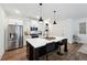 Modern kitchen with stainless steel appliances, a spacious island, and sleek pendant lighting at 2357 Heritage Park Nw Cir # 17, Kennesaw, GA 30144