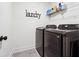 This laundry room contains a washer and dryer with Laundry signage on the wall at 2357 Heritage Park Nw Cir # 17, Kennesaw, GA 30144