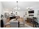 Open-concept living space with modern lighting, stainless steel appliances, and dining area at 2357 Heritage Park Nw Cir # 17, Kennesaw, GA 30144