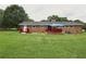 Well-maintained backyard featuring red deck, patio, and ample green space at 5488 Janice Ln, Stone Mountain, GA 30087