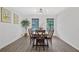 Well-lit dining room featuring a modern chandelier, hardwood floors, and large windows at 5488 Janice Ln, Stone Mountain, GA 30087