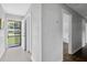 Hallway with wood-look flooring and white walls leading to the front door at 5488 Janice Ln, Stone Mountain, GA 30087