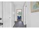 Hallway with wood-look floors and white walls leading to the living area with blue sofa at 5488 Janice Ln, Stone Mountain, GA 30087