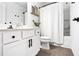 Modern bathroom featuring a shower with white curtain and updated fixtures at 1363 Cooper Springs Rd, Grayson, GA 30017