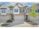 Charming townhome featuring a stone and siding exterior, attached garage, and well-manicured landscaping at 1363 Cooper Springs Rd, Grayson, GA 30017