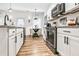 Well-appointed kitchen with stainless steel appliances, granite counters, and a stylish dining area at 1363 Cooper Springs Rd, Grayson, GA 30017