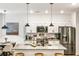 Modern kitchen featuring white cabinets, stainless steel appliances, granite countertops, and pendant lighting at 1363 Cooper Springs Rd, Grayson, GA 30017