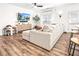 Open-concept living area with hardwood floors, comfy sectional sofa, and a decorative media console at 1363 Cooper Springs Rd, Grayson, GA 30017