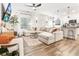 Bright living room open to the kitchen with modern decor, sleek ceiling fan, and hardwood floors at 1363 Cooper Springs Rd, Grayson, GA 30017