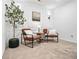A cozy sitting room with comfortable chairs, decorative pillows and a tree at 1363 Cooper Springs Rd, Grayson, GA 30017
