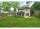 Picturesque backyard featuring a lush lawn, screened porch and mature trees at 1894 Dyer Cir, Atlanta, GA 30341