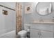 Modern bathroom with shower-tub combo, decorated with neutral colors and tiled walls at 1894 Dyer Cir, Atlanta, GA 30341