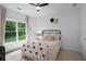 Cozy bedroom featuring a large window, ceiling fan, and stylish decor at 1894 Dyer Cir, Atlanta, GA 30341