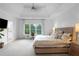 The light-filled main bedroom is complete with a tray ceiling, large windows, and neutral decor at 1894 Dyer Cir, Atlanta, GA 30341