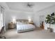 Spacious main bedroom featuring neutral decor, ceiling fan, and staircase access at 1894 Dyer Cir, Atlanta, GA 30341