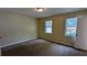 Bedroom featuring carpet flooring, two windows and neutral colored walls at 2015 Corners Cir, Lithonia, GA 30058