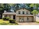 Charming two-story home with a well-maintained front yard surrounded by lush trees at 2015 Corners Cir, Lithonia, GA 30058