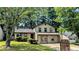 Two-story home with well-kept lawn and mature trees offering shade at 2015 Corners Cir, Lithonia, GA 30058