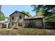 View of the back exterior of the house featuring beige siding, a door to the backyard, and ample natural light at 2015 Corners Cir, Lithonia, GA 30058