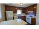 Functional kitchen with vintage wood cabinets and clean white appliances at 2015 Corners Cir, Lithonia, GA 30058