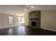 Cozy living room featuring hardwood floors and a striking stone fireplace at 2015 Corners Cir, Lithonia, GA 30058