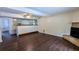Living room with brick fireplace, bar area and dark wood-look flooring at 2015 Corners Cir, Lithonia, GA 30058