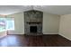 Spacious living room with hardwood floors and a stone fireplace at 2015 Corners Cir, Lithonia, GA 30058