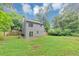 Expansive backyard showing a house with a sliding glass door and serene wooded surroundings at 3130 Glen Knolls Ct, Alpharetta, GA 30022