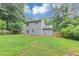 A shot of the home's spacious backyard featuring a well-maintained lawn and a wooden fence for privacy at 3130 Glen Knolls Ct, Alpharetta, GA 30022